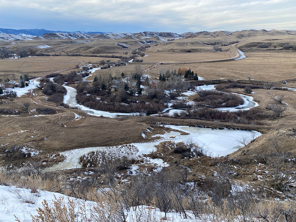 Aerial photo of Jentel buildings surrounded by trees and icy waterways