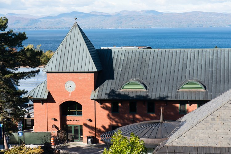 A red building with a green roof on the campus of the Vermont College of Fine Art