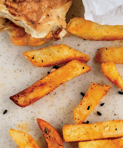 Close-up of the cover of Christopher Gonzalez’s I’m Not Hungry but I Could Eat. Crisp french fries are strewn across a plate. A small sandwich and crumbled napkin are just visible towards the top of the photo. Close-up of the cover of Christopher Gonzalez’s I’m Not Hungry but I Could Eat. Crisp french fries are strewn across a plate. A small sandwich and crumbled napkin are just visible towards the top of the photo.