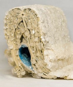 A book, covered in borax crystals and bent in half so that the inner pages face outward.