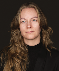 Professional photo portrait of woman in black turtleneck with long, wavy light-brown hair