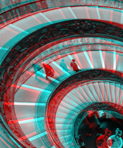 Bird's-eye view of a spiral staircase; photo appears with an anaglyph effect