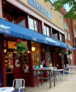 A sidewalk and bookstore entryway. The outside of Trident Bookstore