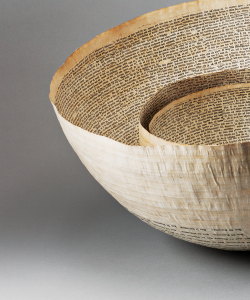 Cropped image of two bowls made out of book pages