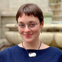 Headshot of Audrey Crooks Headshot of Audrey Crooks, wearing a blue top, glasses, and a silver necklace