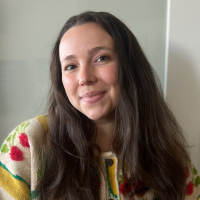Headshot of Hannah Matheson Headshot of Hannah Matheson, wearing a cozy sweater with fall vegetables and smiling