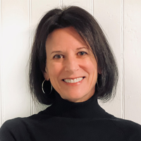 Head shot of Midge Raymond Head shot of Midge Raymond, who is smiling and wearing black turtleneck as